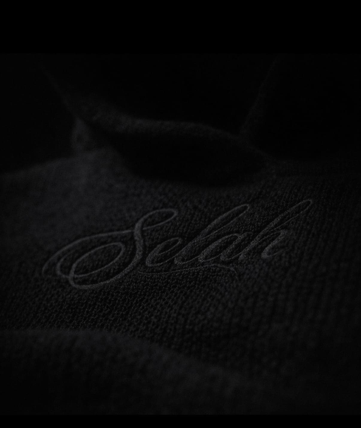 Tonal Selah script embroidered black on black knit