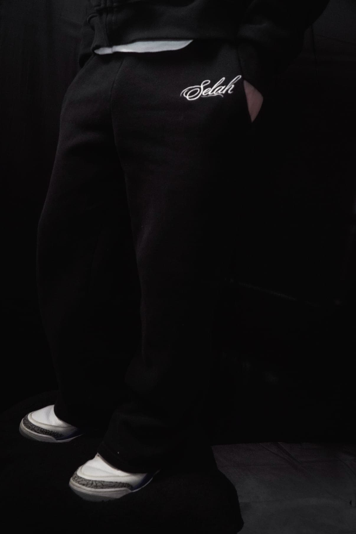 Rosary Sweatpant in matte black with bone Selah embroidery at the hip