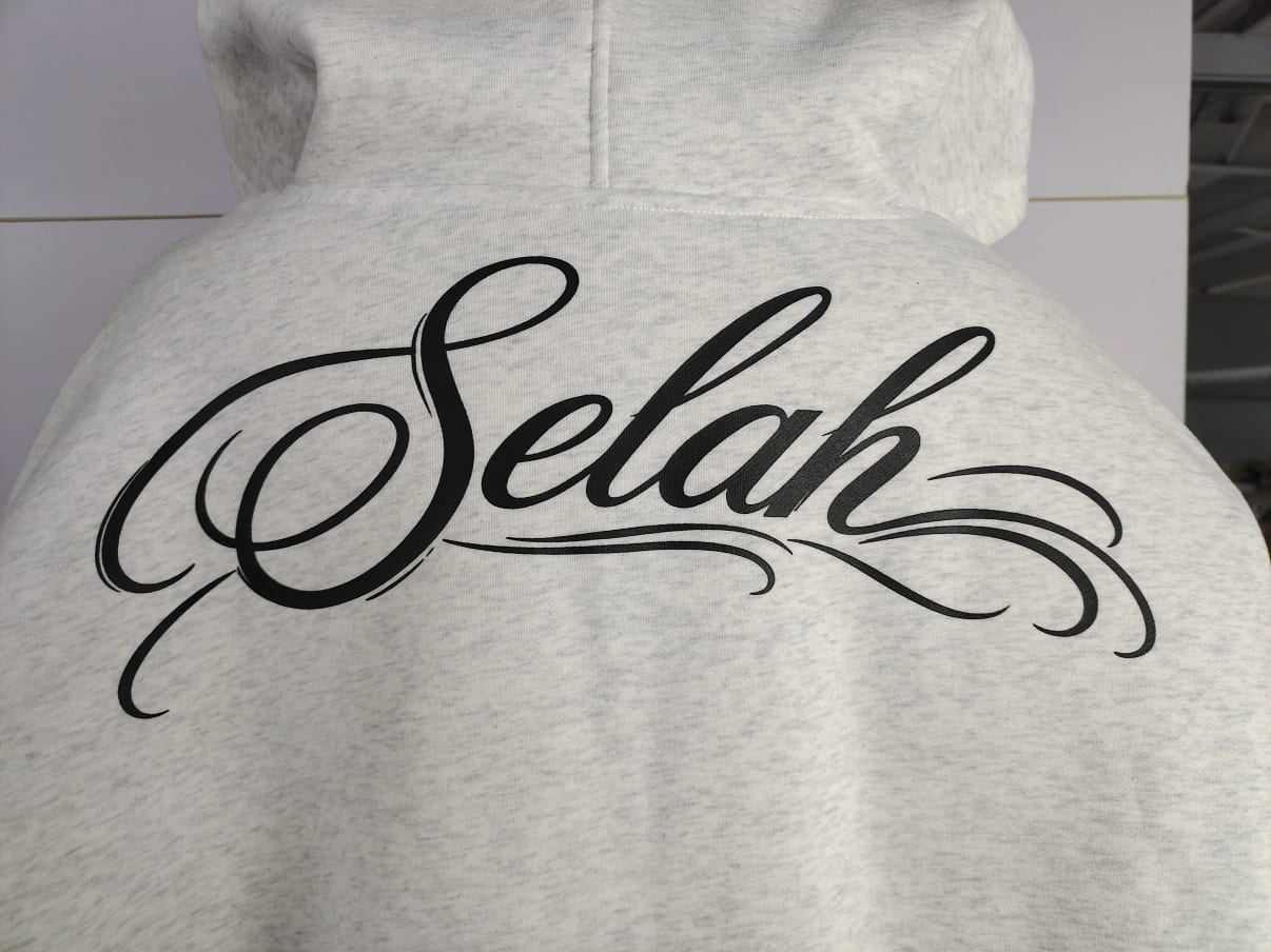 Back Selah script on the washed bone hoodie